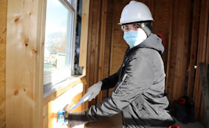 Dale Wolgamuth, currently a senior, is hammering in new work PVC boxes for receptacle and switch locations.