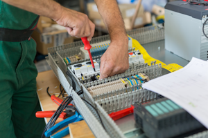 Electrician Installing An Industrial Electrical Cabinet