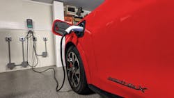 red car charging in garage