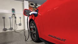 red car charging in garage red car charging in garage