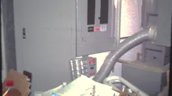 Storage boxes piled up in front of electrical panelboard