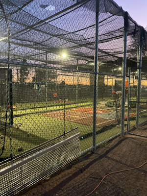 Batting cages at night at Mesa Community College. Donated lights allow baseball players to practice at night.