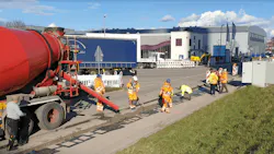 Workers lay components of an Electreon in-road wireless charging project for a bus line in Karlsuhe, Germany in 2020.