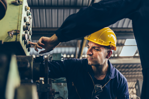 Maintenance Workers Inspecting Machinery
