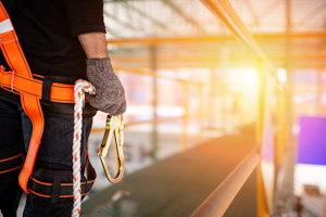 Construction worker wearing fall safety gear
