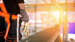 Construction worker wearing fall safety gear