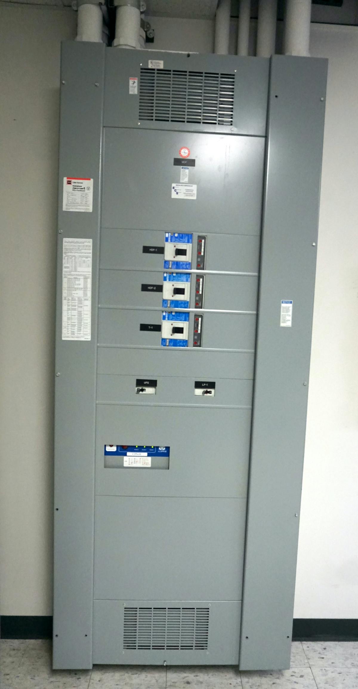 Photo 1. This 480V, 3-phase switchboard must be placed into an electrically safe work condition to remove the front cover and replace a breaker. Several bolts securing the front cover are missing, which would prevent the normal operation of the breakers. Missing bolts will be replaced when the work is completed.