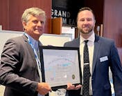 Randy Reid, executive director for the NLB (left), presents an NLB Citation Award to WAC Lighting&apos;s Daniel Moklas.