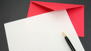 blank sheet of paper with red envelope and pen