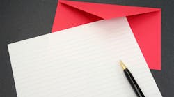 blank sheet of paper with red envelope and pen