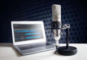 A podcasting mic and laptop
