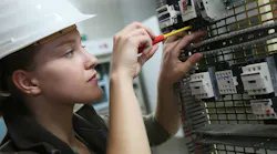 Young Woman In Professional Training Setting Up Electrical Circuit