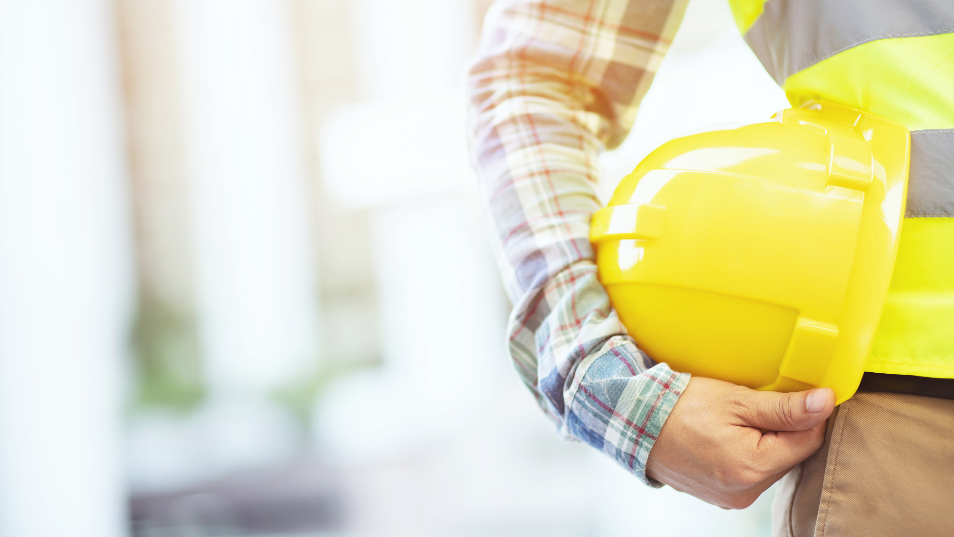 construction worked holding helmet
