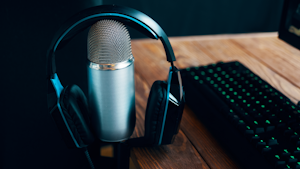 microphone with headphones next to keyboard