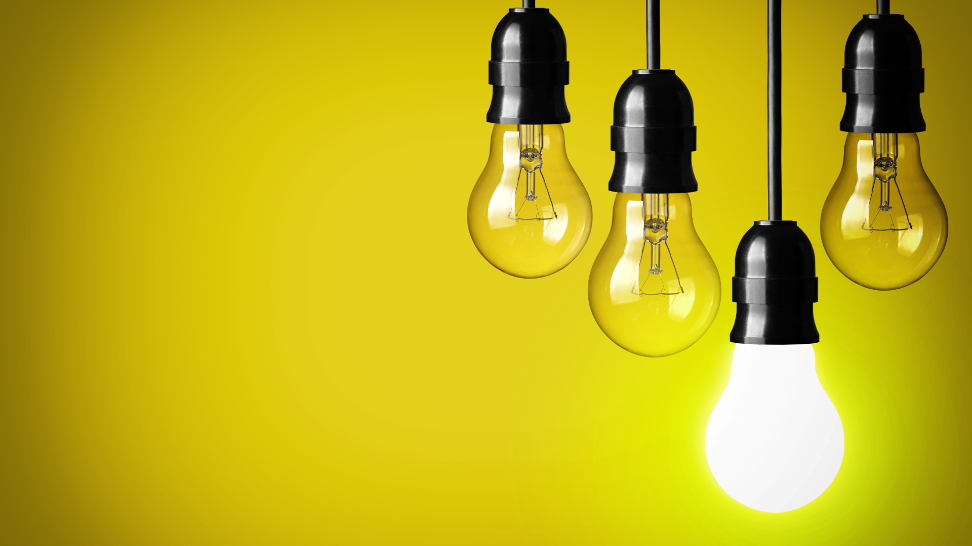hanging lightbulbs in front of yellow background