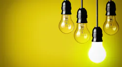 hanging lightbulbs in front of yellow background