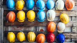rows of construction hats hanging on a wall
