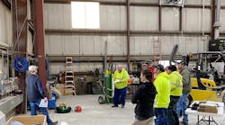 Photo 1. A group of electrical workers gathers to discuss any new technology, new types of equipment, or changes in procedures that would affect the use of safety-related work practices on this particular project.