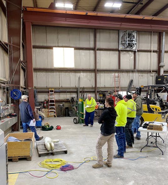 Photo 1. A group of electrical workers gathers to discuss any new technology, new types of equipment, or changes in procedures that would affect the use of safety-related work practices on this particular project.