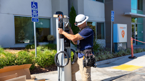 electrical worker installing an ev charging station