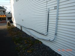 PVC conduit run with no expansion fittings on side of building PVC conduit run with no expansion fittings on side of building