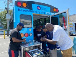 Working to wire the Beyond Literacy bus are (left to right): Attiim Roseborough; Zahir Rawls, The Academy of Industrial Arts (TAIA) student; Jemal Davis, BeLit IT tech and facilities coordinator, and Harold DeLoach, TAIA director of education and master electrician.