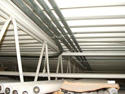 EMT raceways installed on bottom of metal-corrugated sheet roof decking EMT raceways installed on bottom of metal-corrugated sheet roof decking