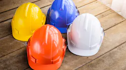 four construction helmets of different colors