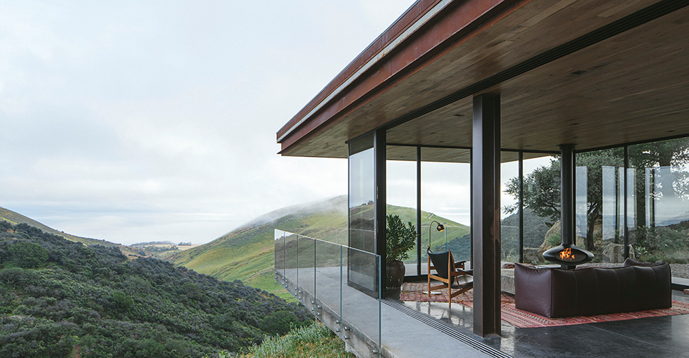 Photo 1. This structure in Central Coast, Calif. is powered by an array of 28 solar panels situated down the hill from the guesthouse to preserve views extending out into the ocean. The panels sit along the grade of the hill to maximize exposure to the sun. The conduit is run underground to the garage where the batteries and inverter live.