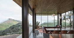 Photo 3. The way the home is nestled into the hillside provides passive insulation limiting the need for any active climate control. Because the home is solar powered, the designer sought to limit the power consumption of the structure, with climate control being a large contributor to a strain on the on-site power management. Photo 3. The way the home is nestled into the hillside provides passive insulation limiting the need for any active climate control. Because the home is solar powered, the designer sought to limit the power consumption of the structure, with climate control being a large contributor to a strain on the on-site power management.