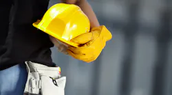 worker holding helmet