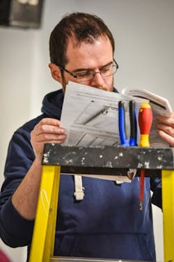 An installer studies connected lighting system instructions on the fly in the Living Lab. An installer studies connected lighting system instructions on the fly in the Living Lab.