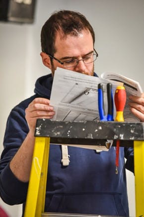 An installer studies connected lighting system instructions on the fly in the Living Lab.