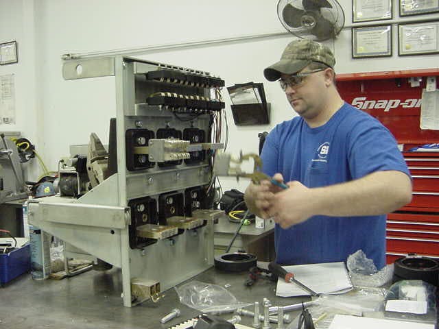Photo 1. A technician working on a Westinghouse low-voltage power circuit breaker.
