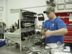 Photo 1. A technician working on a Westinghouse low-voltage power circuit breaker.