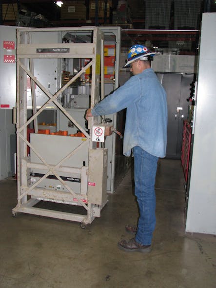 Photo 4b. This technician is using the lifting platform to install a medium-voltage draw-out type vacuum circuit breaker.