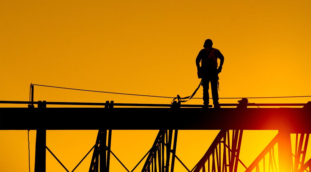 construction worker on site at sunset
