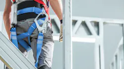 Construction worker wearing fall safety gear