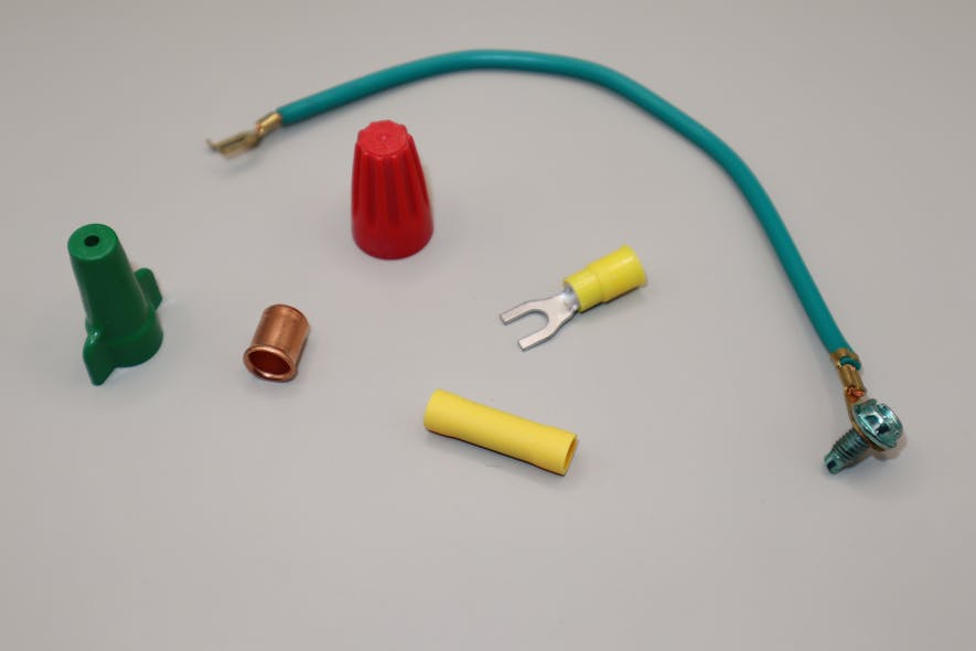 Photo 1. Listed pressure connectors are often used for bonding connections. Typical connectors are twist-on type connectors and tool-crimped connectors. At left is a green twist-on connector with a hole in the top to allow pushing through of a solid equipment grounding conductor to bond to the wiring device. The green bonding jumper at the top is prefabricated with listed tool-crimp connectors at each end. The red twist-on connector can be used for grounding and bonding applications. The tool-applied crimps (bottom center) are listed for stranded conductors only.