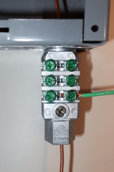 Photo 3b. NEC Sec. 250.94 requires bonding for communication systems. One of the two options is the use of an Intersystem Bonding Termination (IBT) device. This IBT bonds communication wiring (green conductor) to the grounding electrode conductor at the service exterior to the service enclosure.