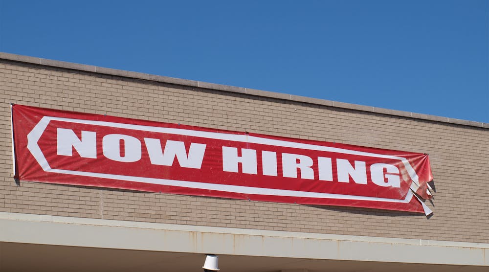 now hiring sign on building