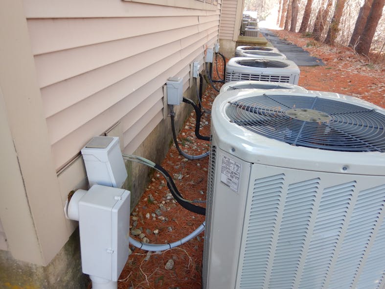 air conditioning units with disconnect installed behind unit