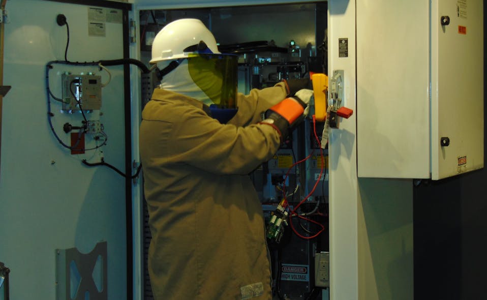 Photo 3. Verifying an electrically safe work condition is considered working on live parts because components may still be energized. Most workers experience some uneasiness working on energized circuits as they should. PPE is generally not comfortable to wear. What else could the worker be thinking about during this task?