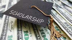 Scholarship graduation cap on money