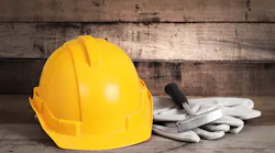 construction hard hat with gloves and tool