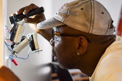 An electrician installs AC-powered controls in an NGLS living lab An electrician installs AC-powered controls in an NGLS living lab