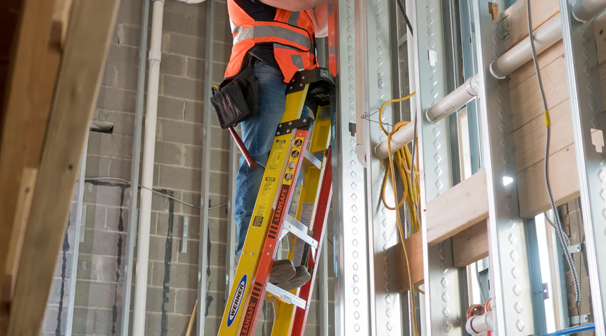 Worker Using Ladder Five Ways to Make Ladders Safer | EC&M