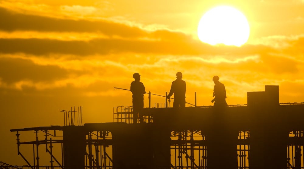 construction workers on site at sunrise