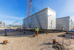 Workers set one of 122 battery containers at the Moss Landing battery energy storage site. Each container is home to 924 battery modules. The containers were engineered, pre-fabricated, and shipped from Pittsburgh, Kan. to Moss Landing, Calif., where they were set into place by Burns & McDonnell’s self-perform construction team. Workers set one of 122 battery containers at the Moss Landing battery energy storage site. Each container is home to 924 battery modules. The containers were engineered, pre-fabricated, and shipped from Pittsburgh, Kan. to Moss Landing, Calif., where they were set into place by Burns & McDonnell’s self-perform construction team.