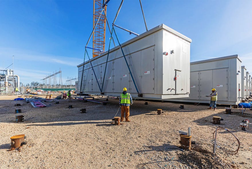 Workers set one of 122 battery containers at the Moss Landing battery energy storage site. Each container is home to 924 battery modules. The containers were engineered, pre-fabricated, and shipped from Pittsburgh, Kan. to Moss Landing, Calif., where they were set into place by Burns &amp; McDonnell&rsquo;s self-perform construction team.